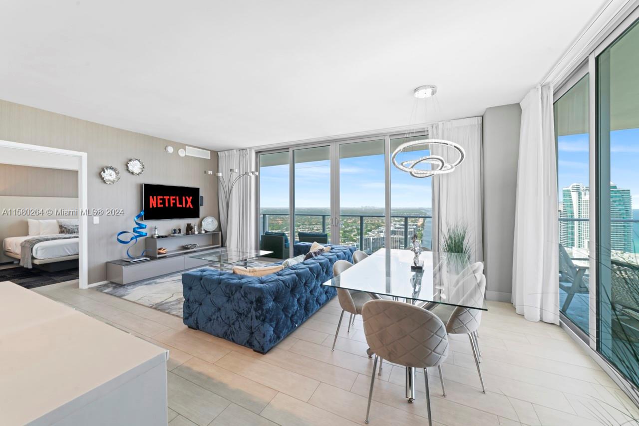 4010 South Ocean Drive, Unit R3001 Hollywood, FL 33019 - Photo 34 of 44 a living room with furniture and a flat screen tv