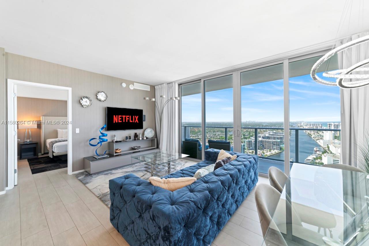 4010 South Ocean Drive, Unit R3001 Hollywood, FL 33019 - Photo 36 of 44 a living room with furniture and a flat screen tv