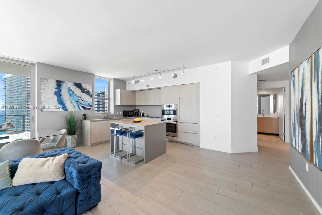 4010 South Ocean Drive, Unit R3001 Hollywood, FL 33019 - Photo 39 of 44 a living room with furniture and a kitchen