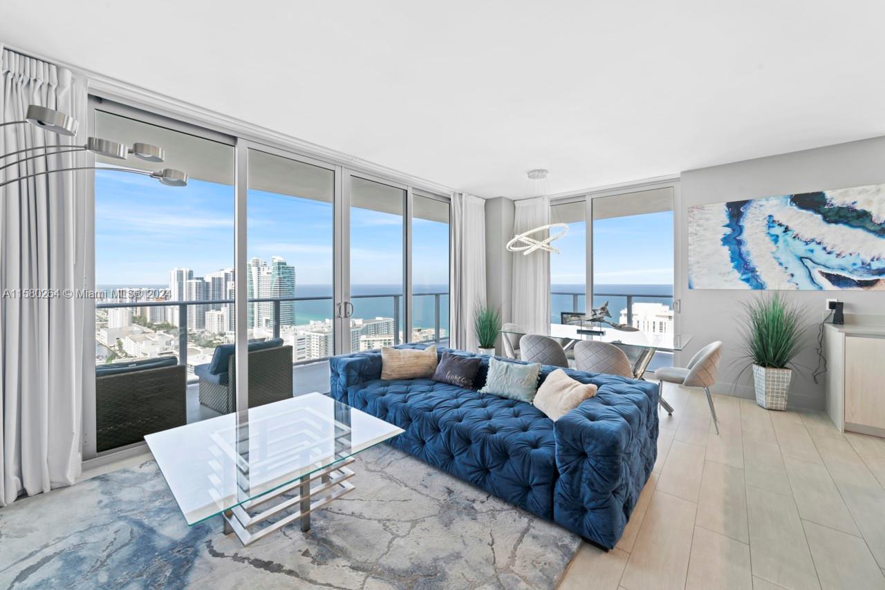 4010 South Ocean Drive, Unit R3001 Hollywood, FL 33019 - Photo 44 of 44 a living room with furniture large windows and wooden floor
