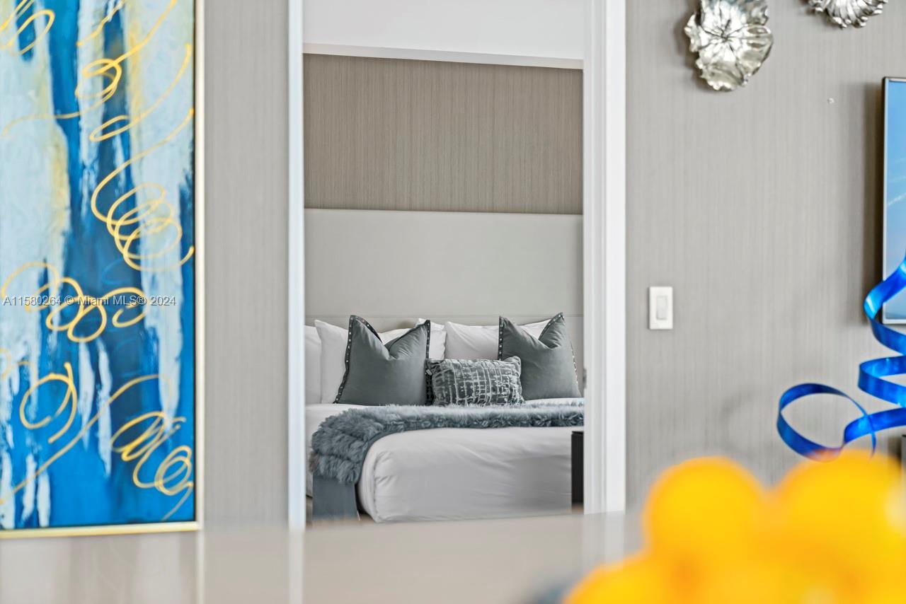 4010 South Ocean Drive, Unit R3001 Hollywood, FL 33019 - Photo 6 of 44 a bedroom with a bed and a painting on the wall