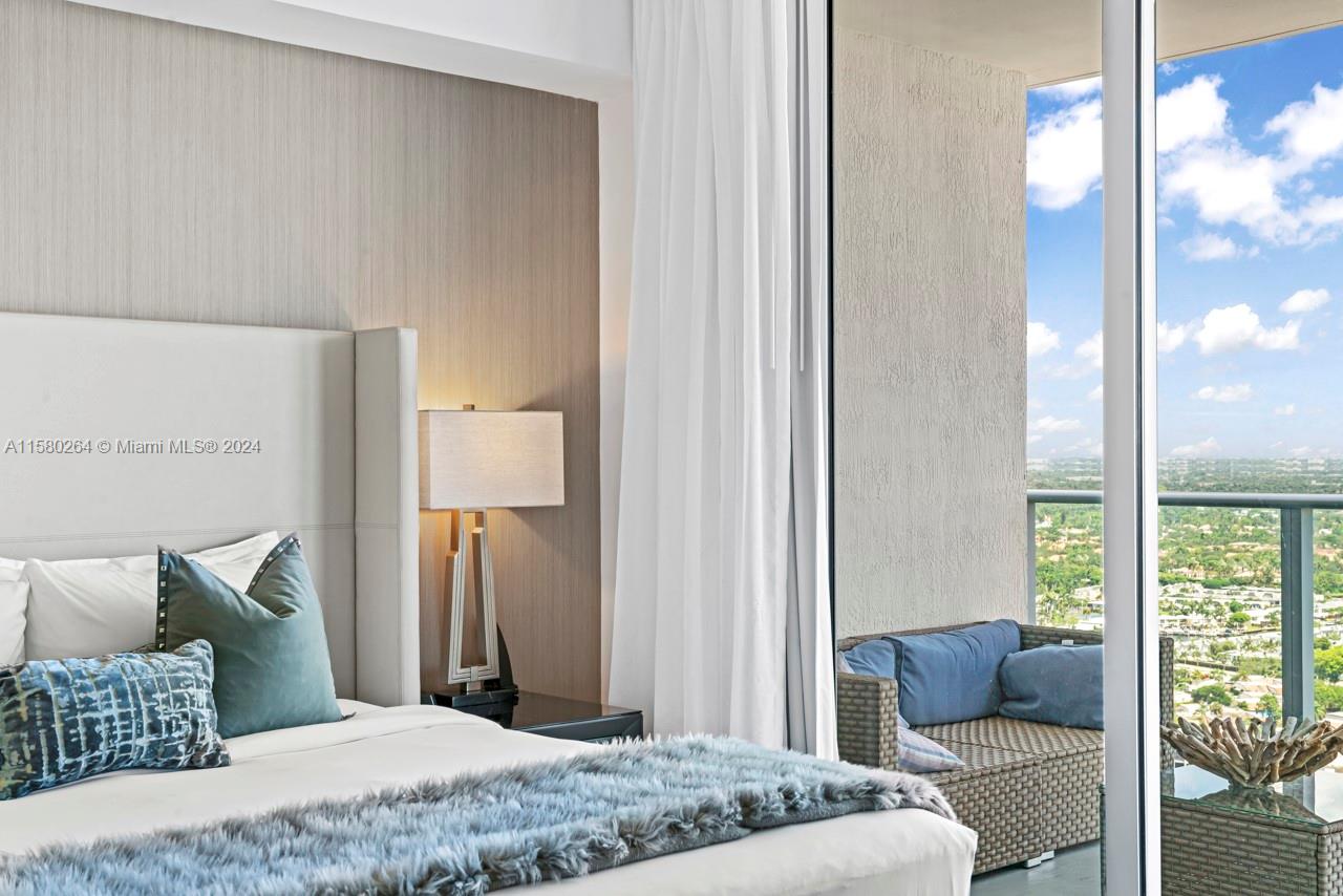 4010 South Ocean Drive, Unit R3001 Hollywood, FL 33019 - Photo 7 of 44 a bedroom with a bed and wooden floor