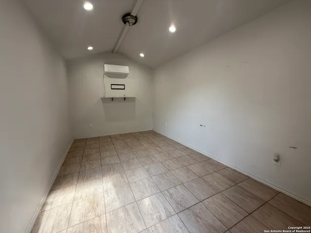 an empty room with a empty space and a ceiling fan