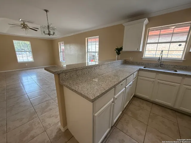 a kitchen with a sink stove and cabinets