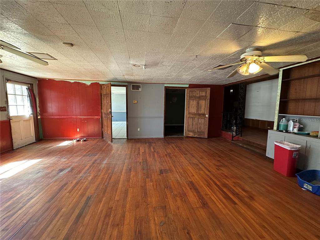 513 West Main Street Wauchula, FL 33873 - Photo 29 of 43 an empty room with wooden floor and windows