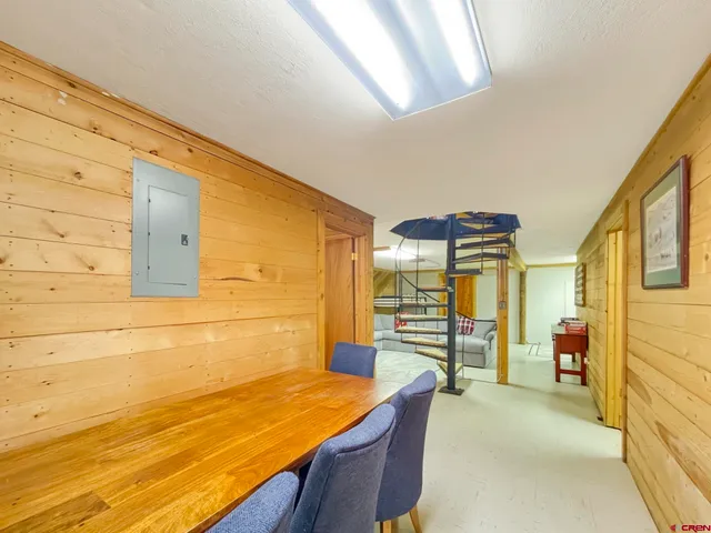 a room with table chair and glass door