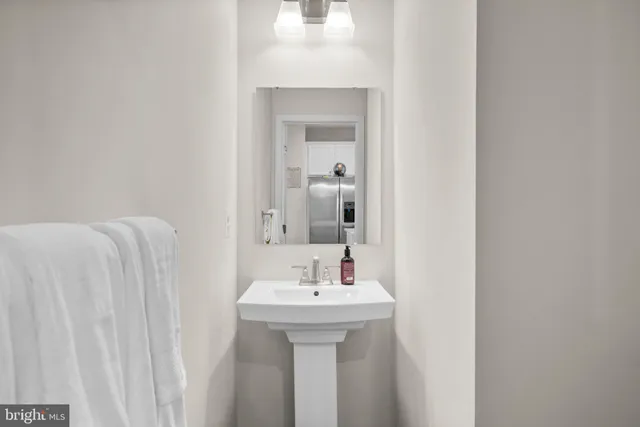 a bathroom with a sink a mirror and vanity