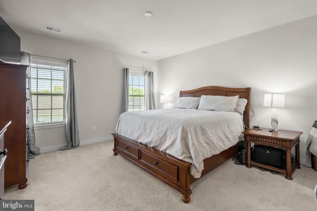 a spacious bedroom with a bed and a window