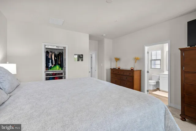a large bedroom with closet area