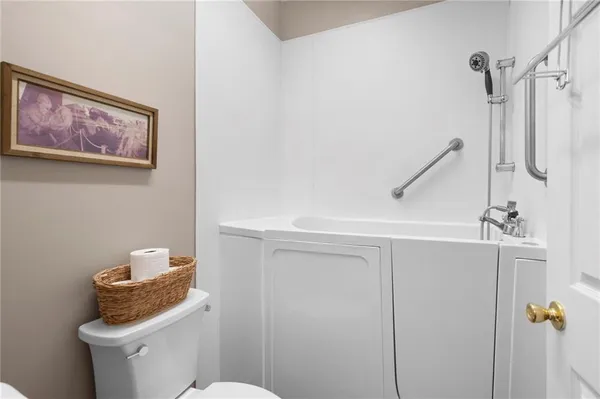 a bathroom with a toilet and a shower