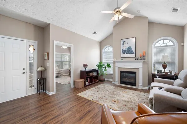 a living room with furniture and a fireplace