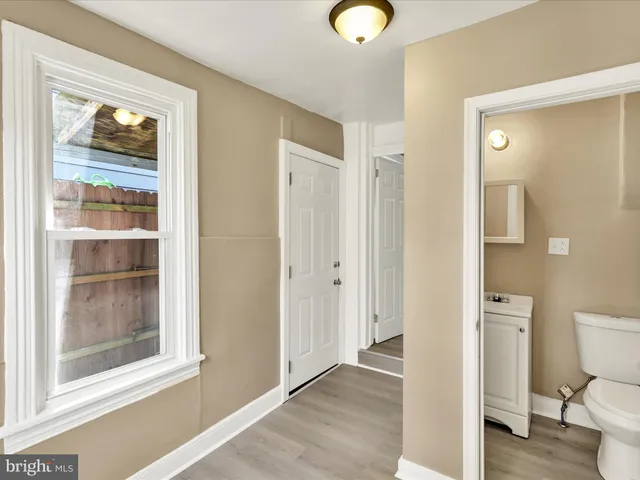 a bathroom with a toilet shower and a window