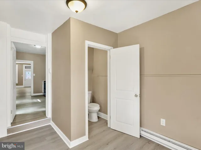 a view of an empty room and wooden floor