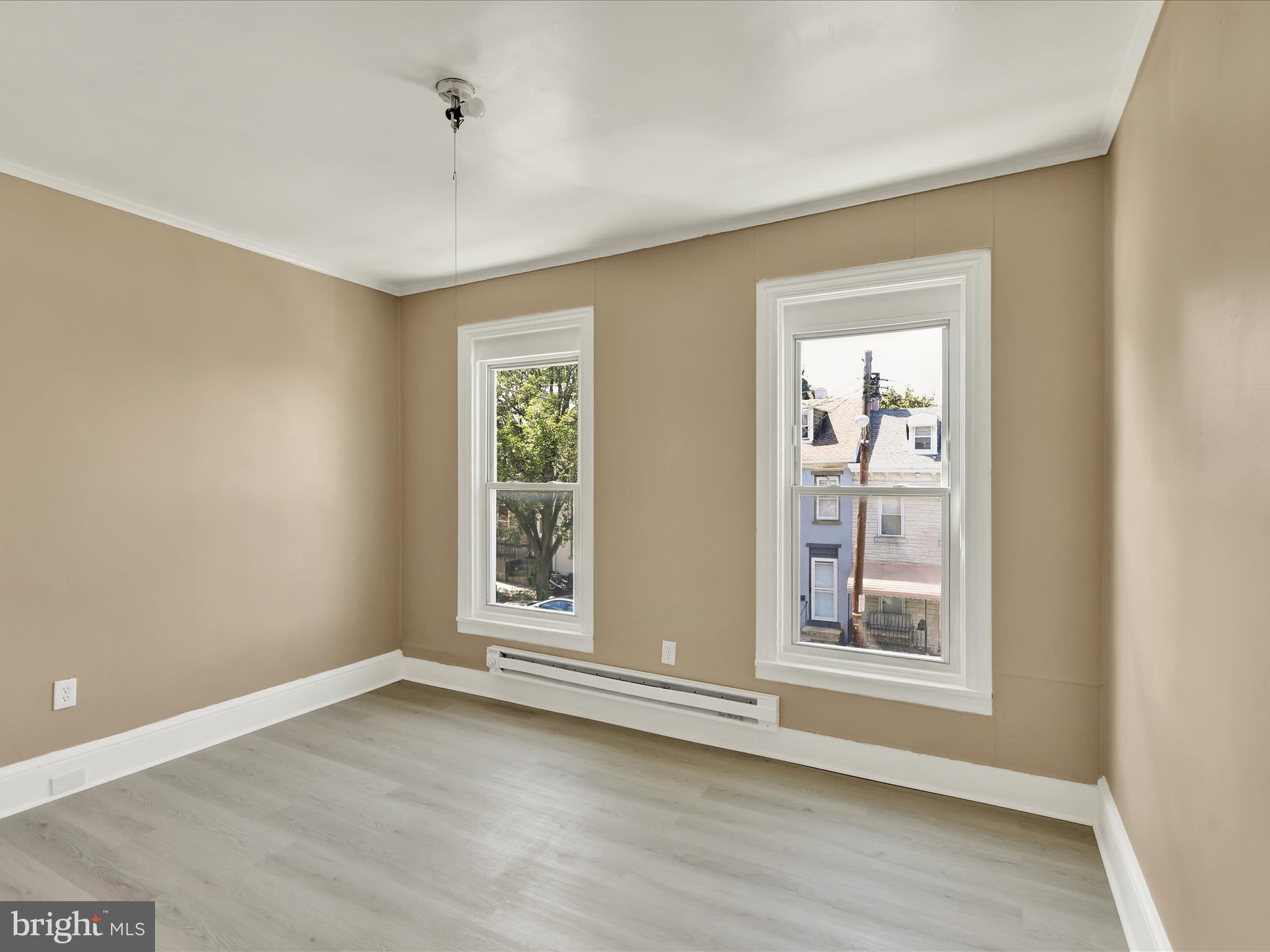 541 South 11th Street Reading, PA 19602 - Photo 15 of 24 an empty room with wooden floor and windows