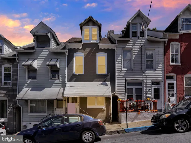 a front view of a building with parking space