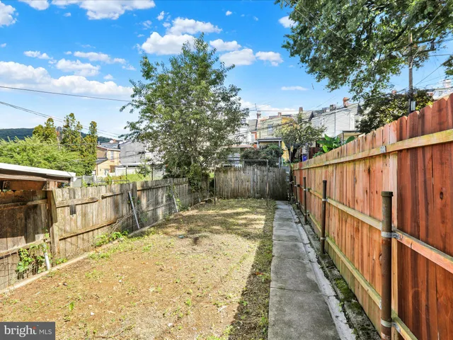 a view of a balcony with wooden floor and fence