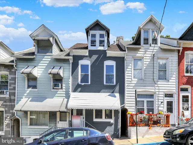 a front view of a residential apartment building with a yard