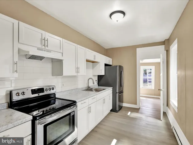 a kitchen with a stove and a refrigerator