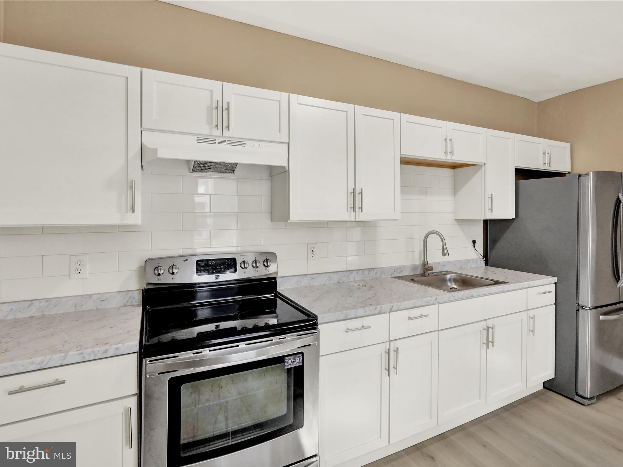 541 South 11th Street Reading, PA 19602 - Photo 9 of 24 a kitchen with appliances a sink and cabinets