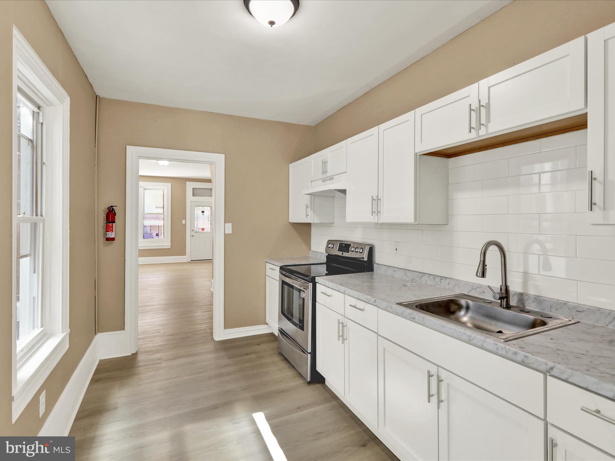 541 South 11th Street Reading, PA 19602 - Photo 10 of 24 a kitchen with stainless steel appliances granite countertop a sink and cabinets