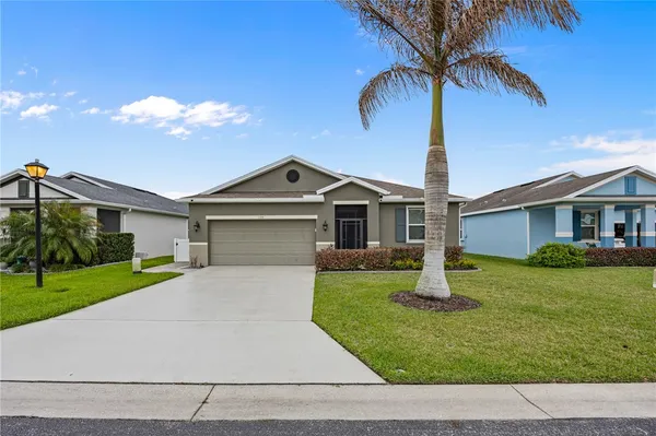 a front view of a house with a yard and garage
