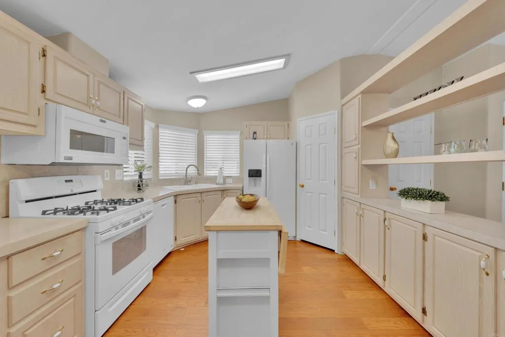 1815 Sweetwater Road, Unit 169 Spring Valley, CA 91977 - Photo 18 of 50 a kitchen with white cabinets and appliances