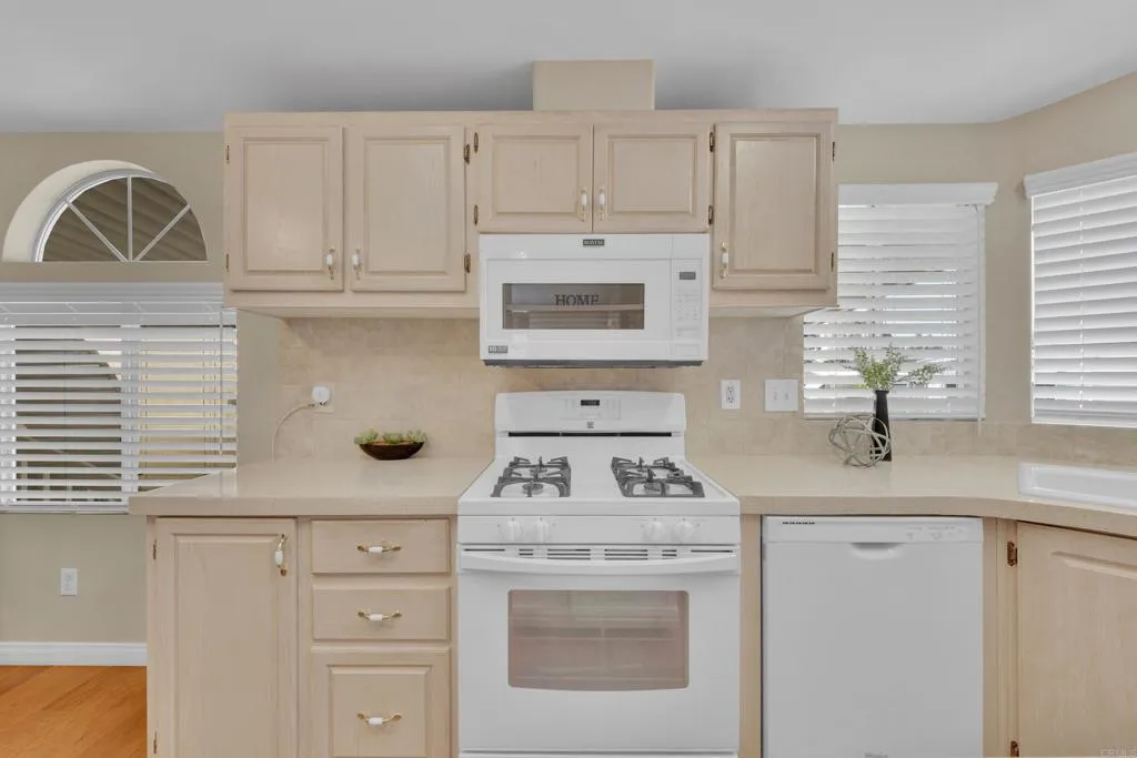 1815 Sweetwater Road, Unit 169 Spring Valley, CA 91977 - Photo 19 of 50 a kitchen with white cabinets and sink