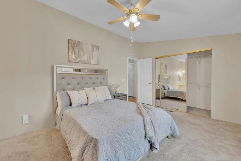 1815 Sweetwater Road, Unit 169 Spring Valley, CA 91977 - Photo 25 of 50 a spacious bedroom with a bed and a chandelier