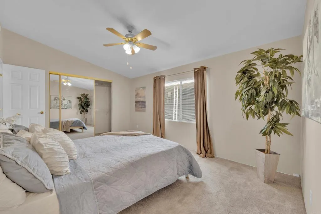 1815 Sweetwater Road, Unit 169 Spring Valley, CA 91977 - Photo 26 of 50 a bedroom with a large bed and a chandelier
