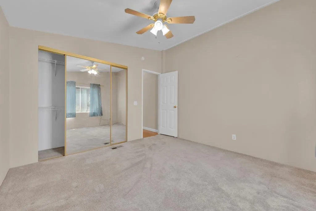 1815 Sweetwater Road, Unit 169 Spring Valley, CA 91977 - Photo 35 of 50 an empty room with closet and a chandelier fan