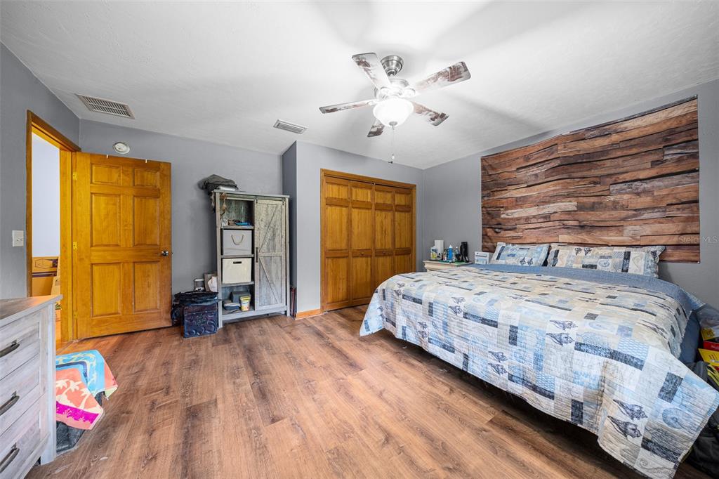 732 Carl Wilson Road Fort White, FL 32038 - Photo 25 of 80 a bedroom with a bed and wooden floor
