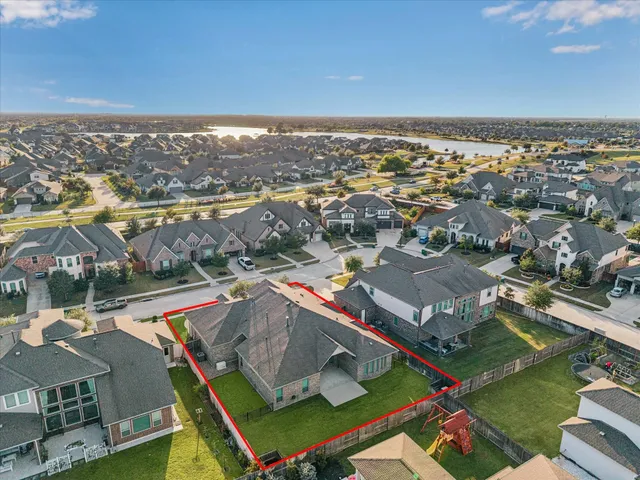 an aerial view of residential houses with outdoor space and swimming pool