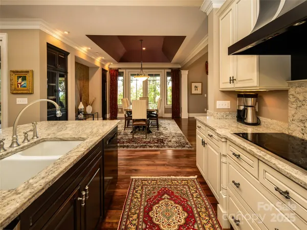a large kitchen with granite countertop a sink and a stove