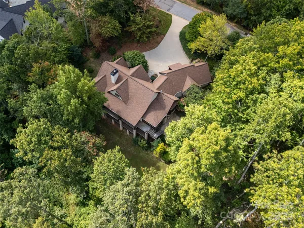 an aerial view of a house with garden space and street view