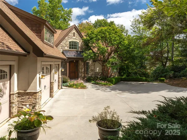 a front view of a house with a yard and a garden