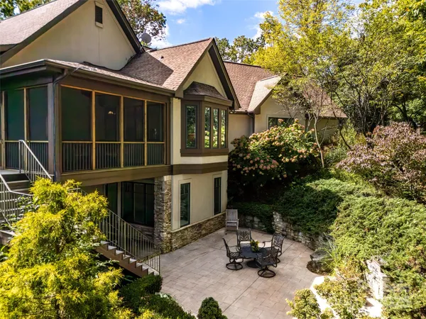 a backyard of a house with table and chairs