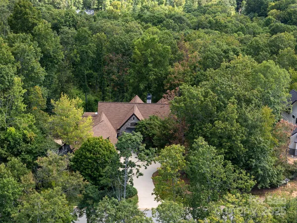 an aerial view of a house with yard and outdoor seating