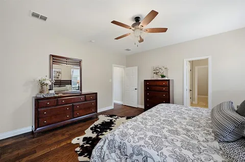 a bedroom with a bed and a dresser