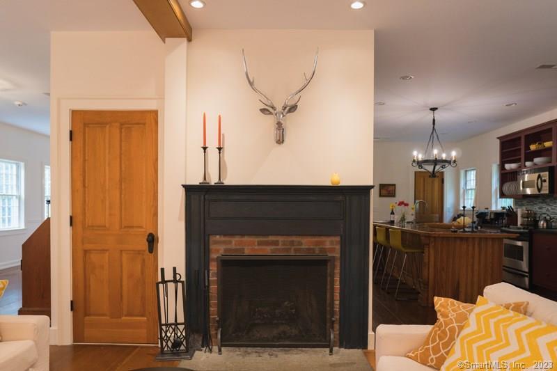 33 Sentry Hill Road Roxbury, CT 06783 - Photo 10 of 27 a living room with furniture a fireplace and a chandelier