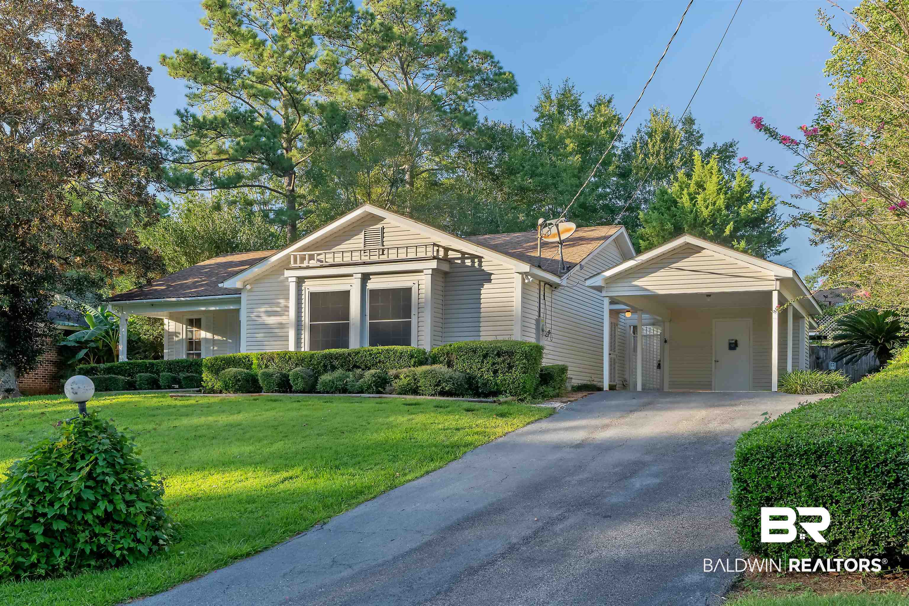 438 Ridgewood Drive Daphne, AL 36526 - Photo 26 of 28 View of front facade featuring a carport, covered porch, and a front yard