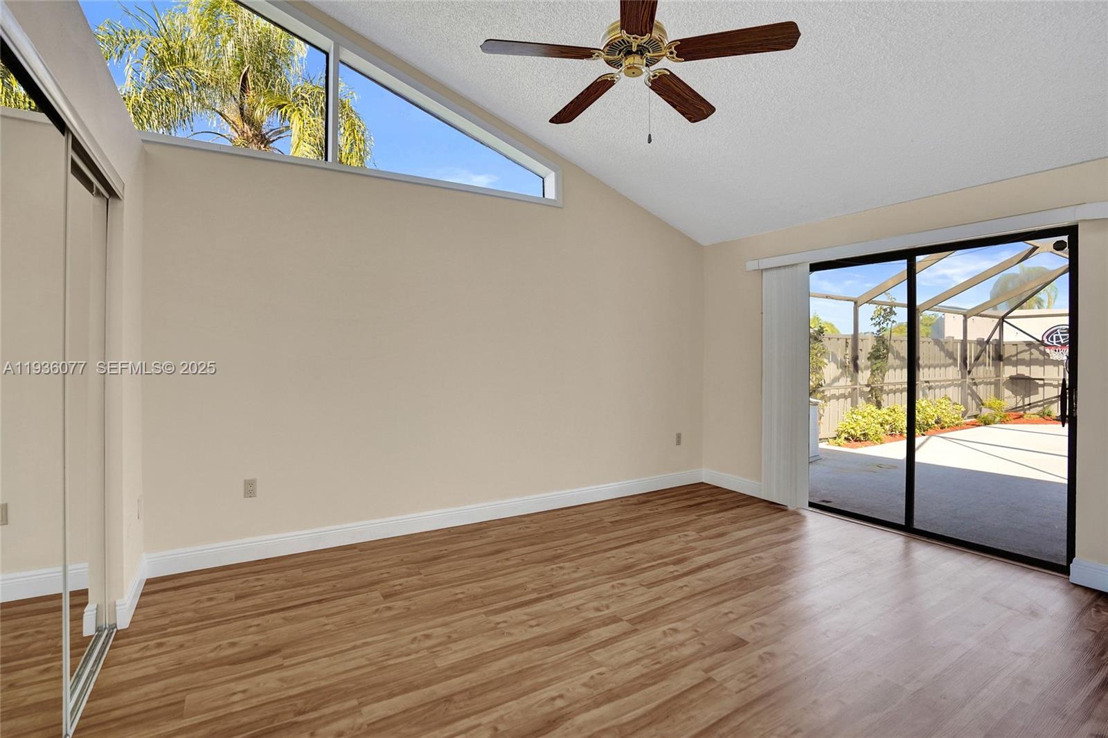 9569 Boca Gardens Parkway, Unit B Boca Raton, FL 33496 - Photo 12 of 40 wooden floor in an empty room with a window