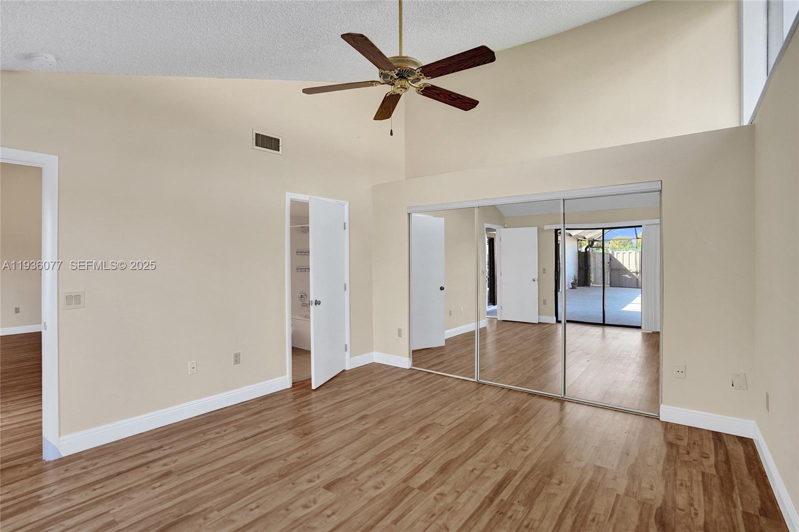 9569 Boca Gardens Parkway, Unit B Boca Raton, FL 33496 - Photo 16 of 40 an empty room with wooden floor and windows