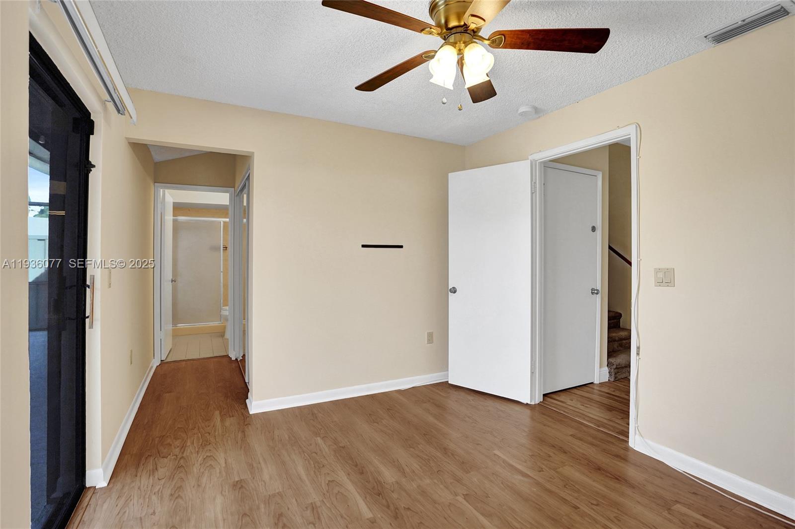 9569 Boca Gardens Parkway, Unit B Boca Raton, FL 33496 - Photo 20 of 40 a view of a hallway with wooden floor and a chandelier fan