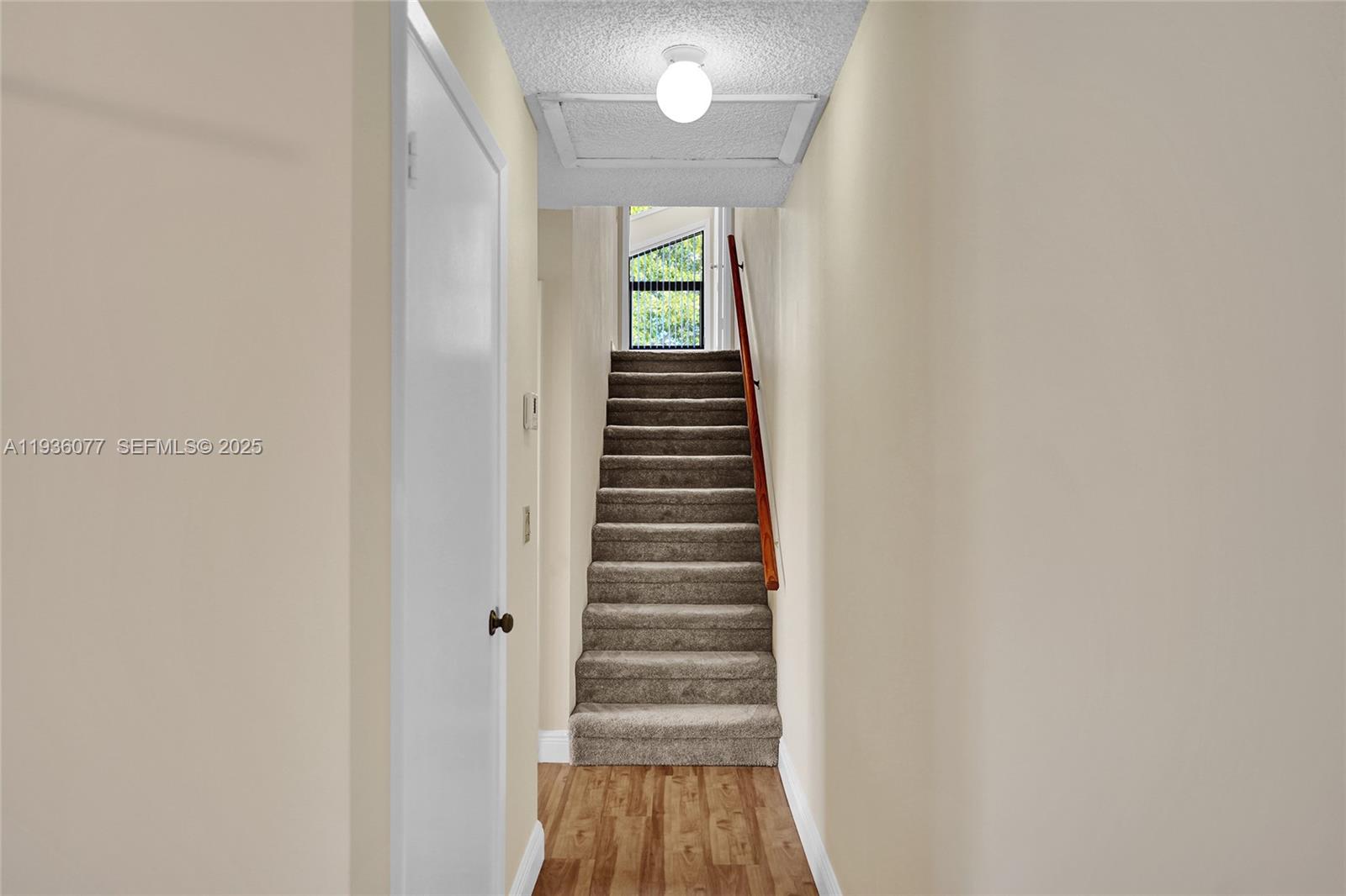 9569 Boca Gardens Parkway, Unit B Boca Raton, FL 33496 - Photo 21 of 40 a view of a hallway with stairs and a window