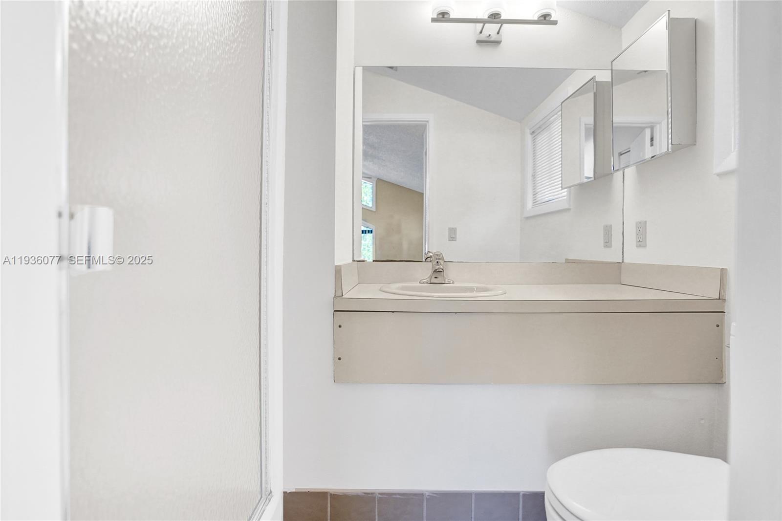 9569 Boca Gardens Parkway, Unit B Boca Raton, FL 33496 - Photo 24 of 40 a bathroom with a sink toilet and mirror