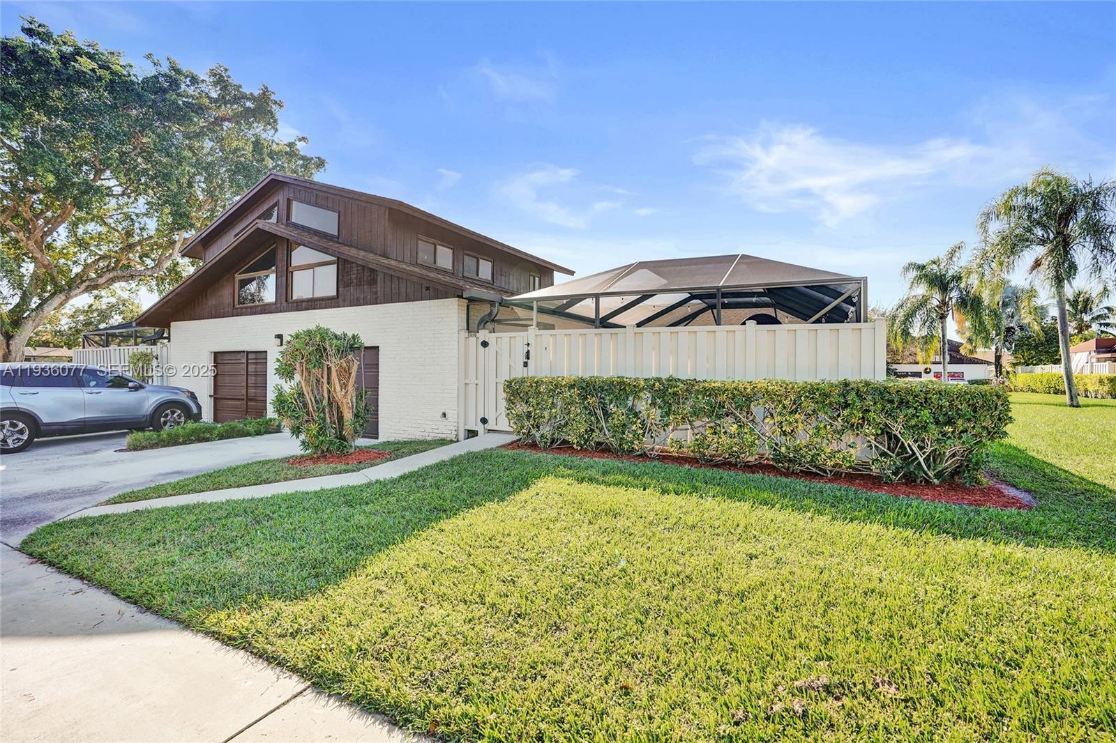 9569 Boca Gardens Parkway, Unit B Boca Raton, FL 33496 - Photo 28 of 40 a front view of a house with a yard and garage