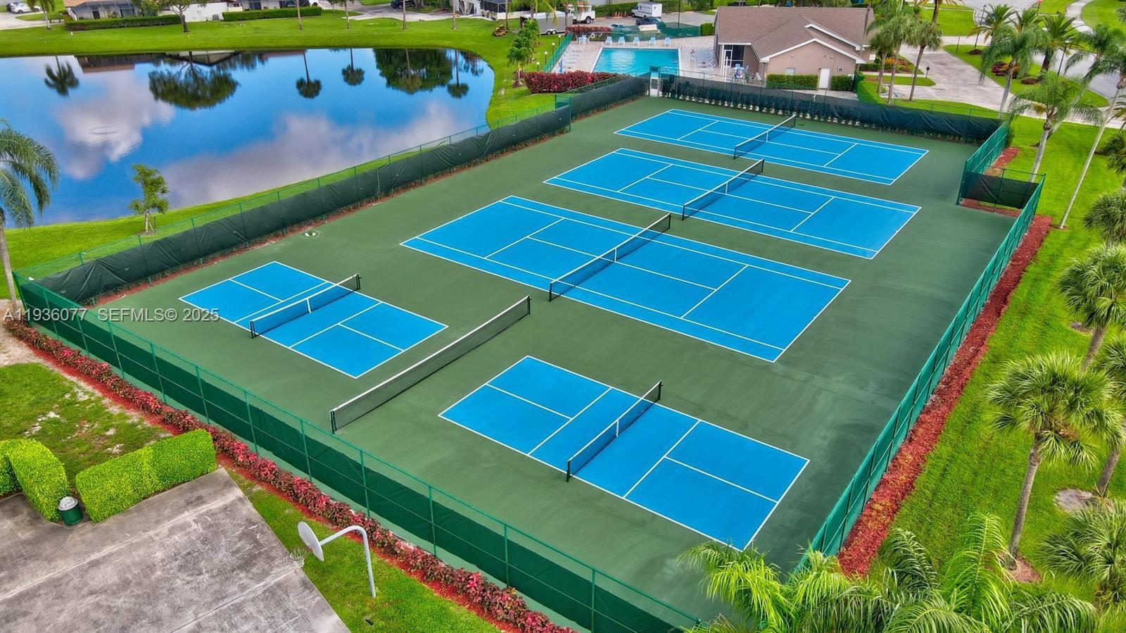 9569 Boca Gardens Parkway, Unit B Boca Raton, FL 33496 - Photo 35 of 40 a view of a tennis ground with large trees