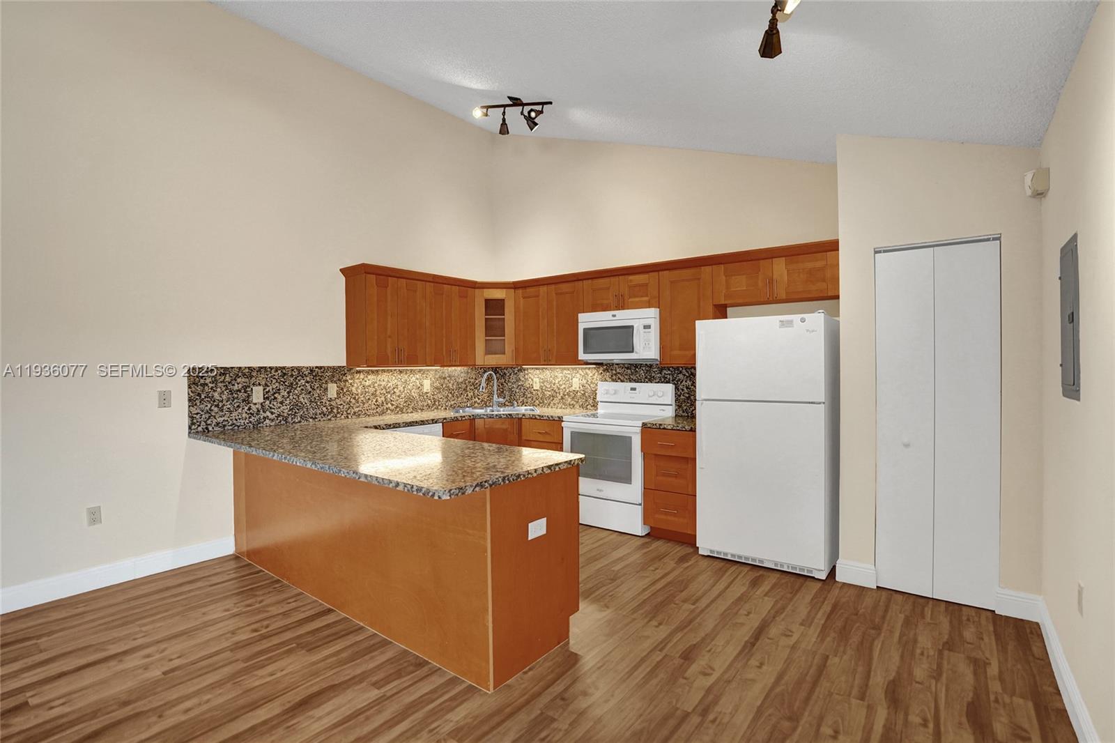 9569 Boca Gardens Parkway, Unit B Boca Raton, FL 33496 - Photo 6 of 40 a kitchen with stainless steel appliances granite countertop a refrigerator a stove and a wooden floors
