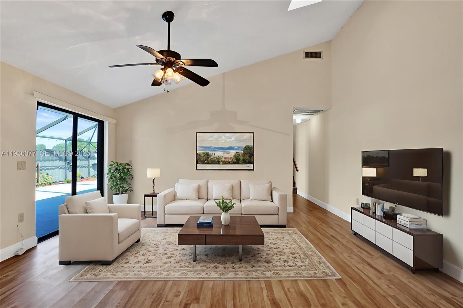9569 Boca Gardens Parkway, Unit B Boca Raton, FL 33496 - Photo 7 of 40 a living room with furniture and a flat screen tv