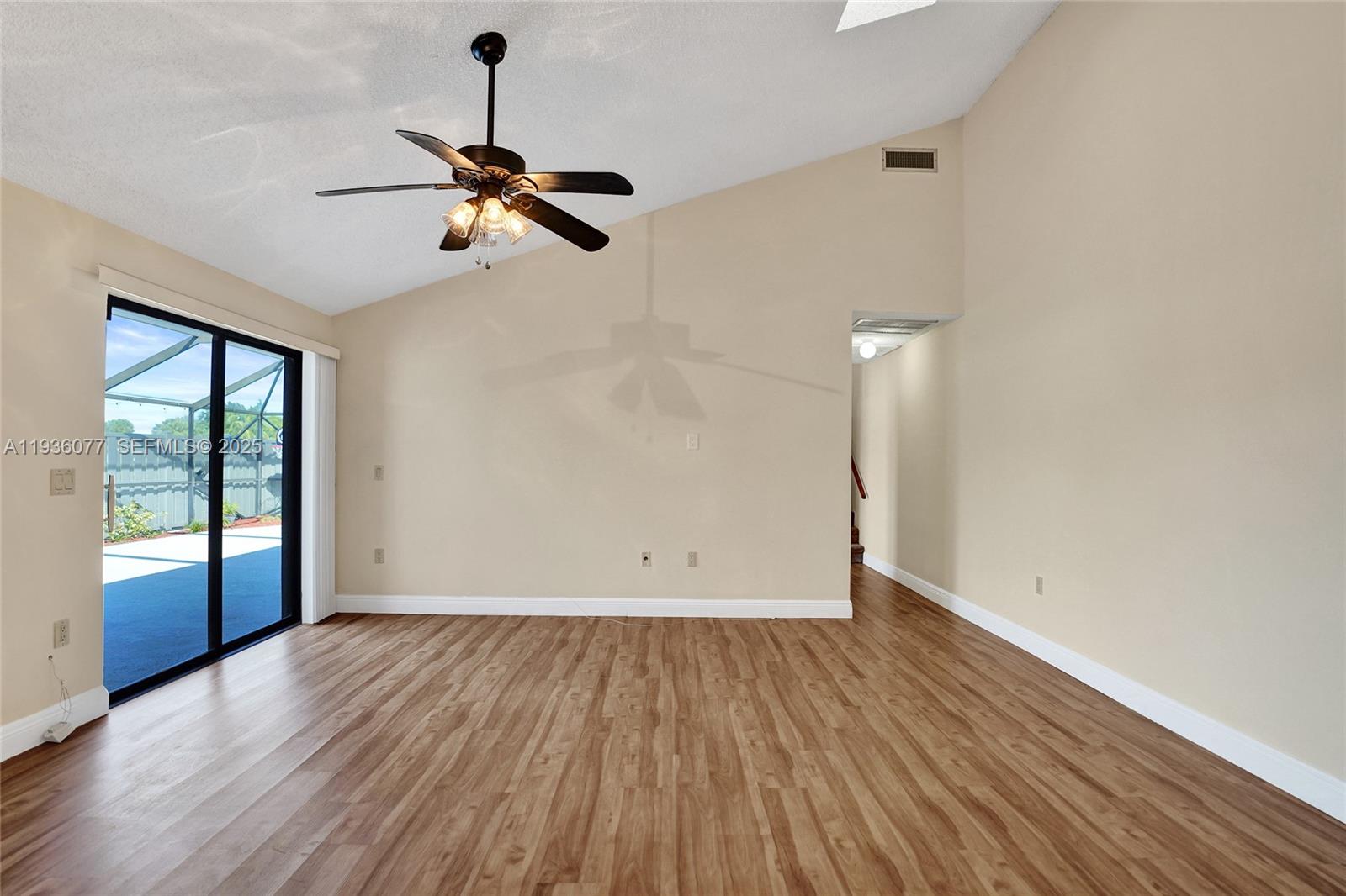 9569 Boca Gardens Parkway, Unit B Boca Raton, FL 33496 - Photo 8 of 40 a view of empty room with wooden floor and fan